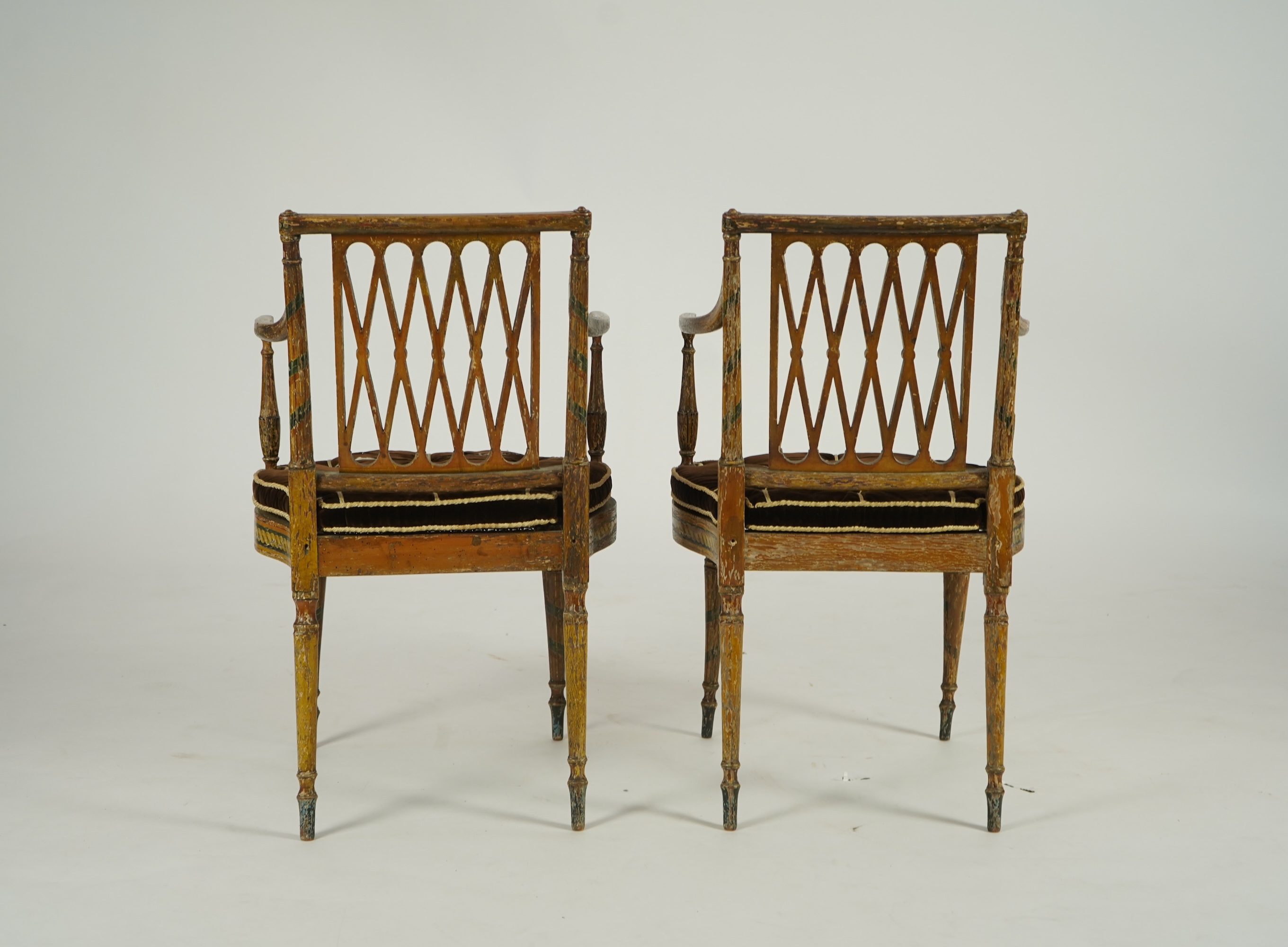 A set of six Sheraton period painted decorated cane seat elbow chairs